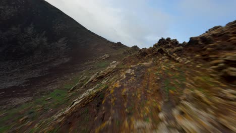 fuerteventura vulcan fpv aerial dive in from rocky ridge slowmotion 50fps