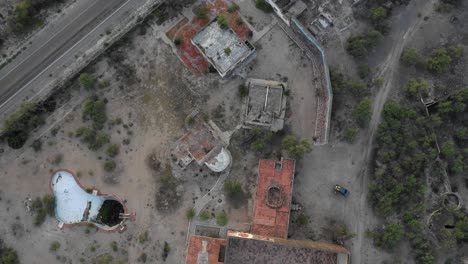 aerial view of abandoned buildings and ruins in a desert landscape