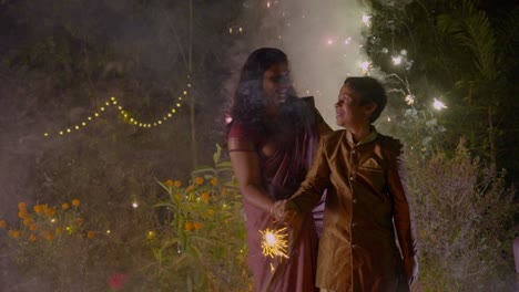 diwali celebrating a family family bursting firecrackers in diwali festival in india, mother and child enjoying with firecrackers