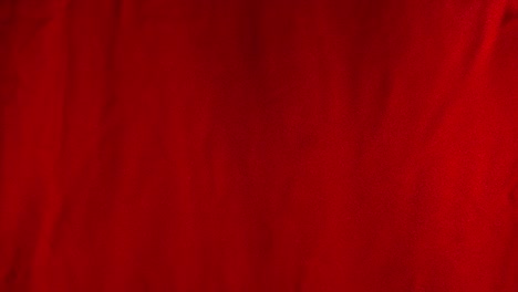 tela de seda roja que fluye sopla en el viento en cámara lenta textura de fondo /