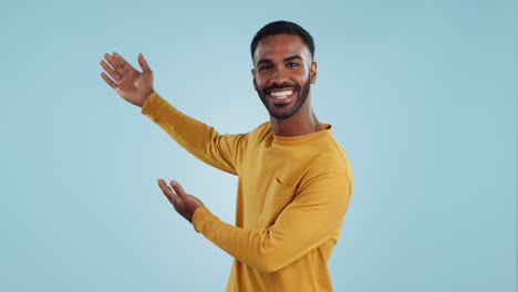 happy, face and man with hand pointing in studio