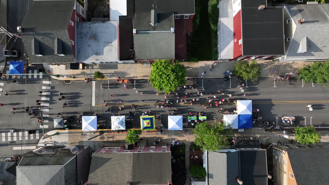 Aerial top down showing many people on street celebrating food festival event in lititz, Pennsylvania,. Sunny day in summer. tent with different foods.