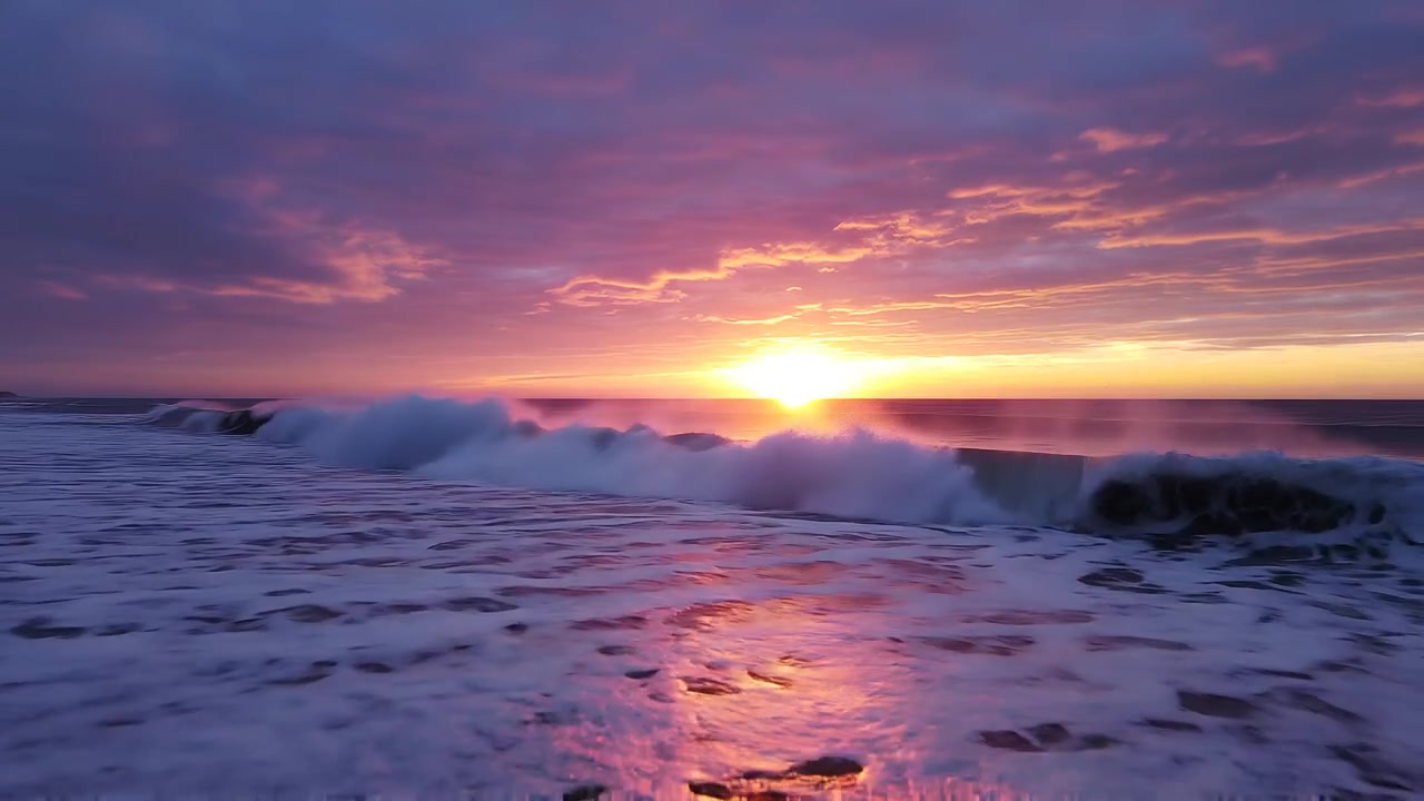Breathtaking Ocean Sunset with Breaking Waves and Colorful Sky