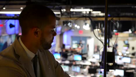 rack focus of business man looking out over busy office