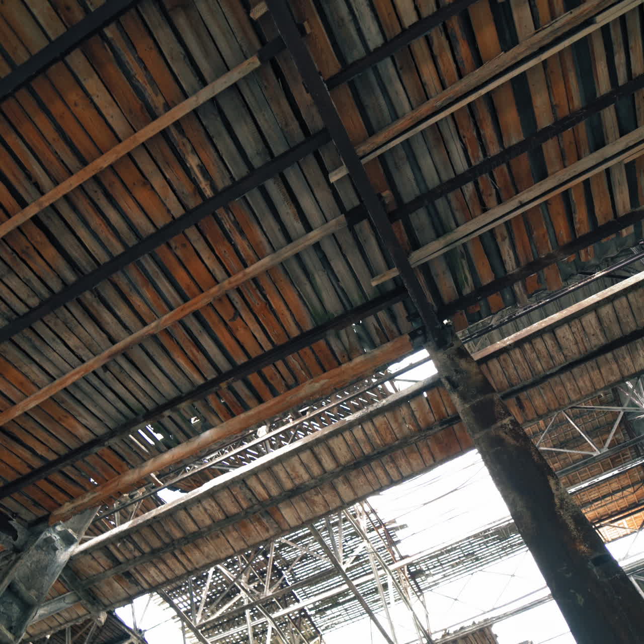 Inside old ruined building with collapsed roof and overgrown with grass, catastrophe or earthquake consequences, toned