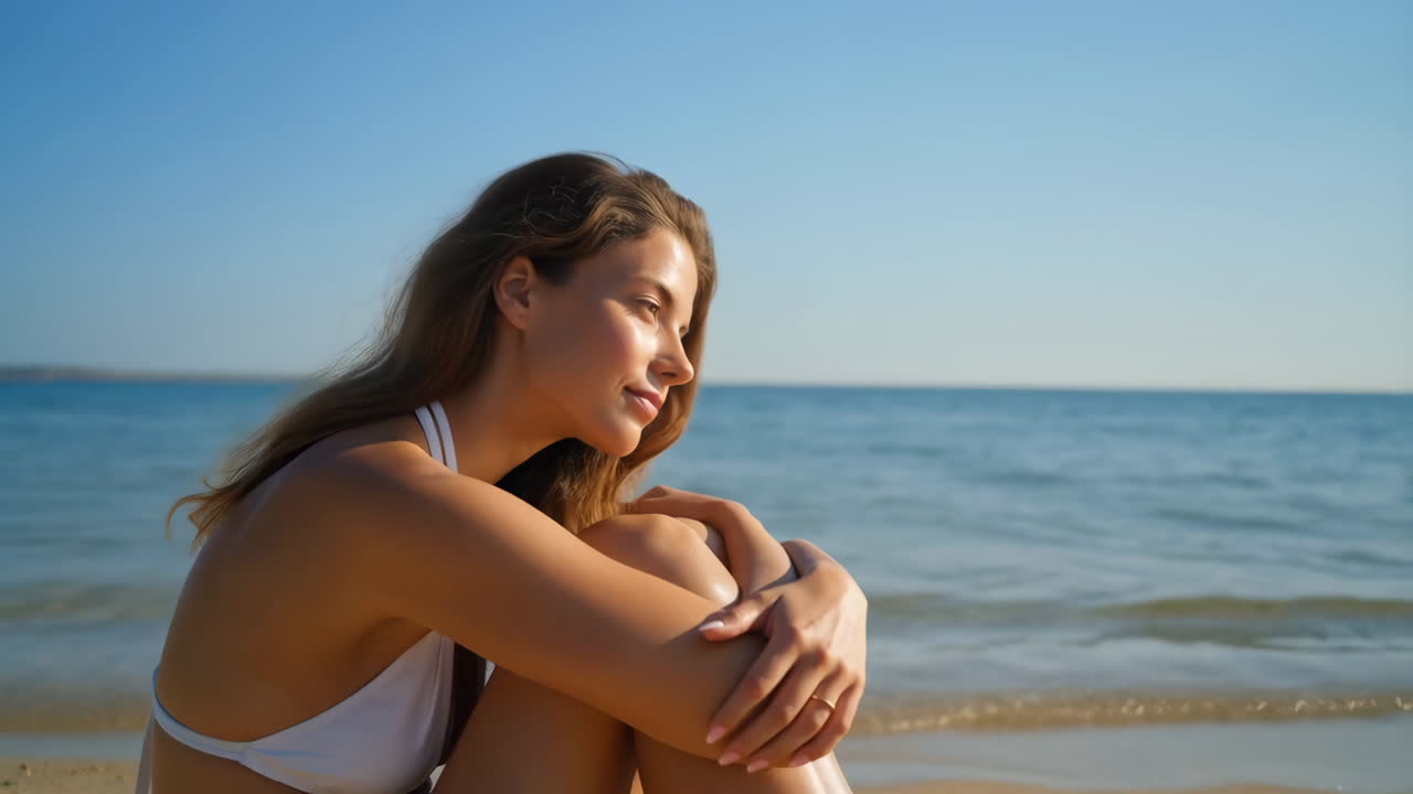 Young Woman Relaxing on a Peaceful Beach by the Ocean