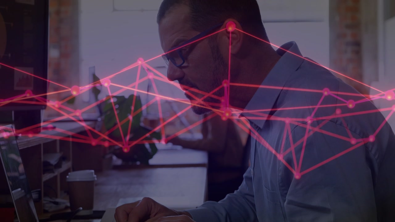 Man typing at laptop in tech activating animated network nodes showing data aligning near eye level