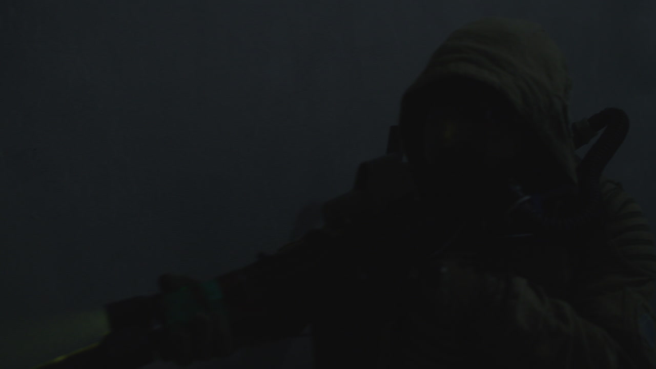 A wounded soldier in the abandoned military complex approaches anomaly