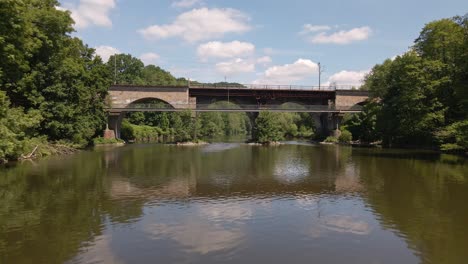 Old-train-trestle-made-from-brick-and-metal-connecting-the-two-banks-of-the-Sieg-river-in-Schladern,-Germany