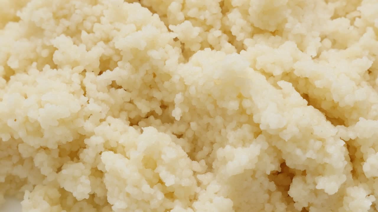 Cous Cous served on the plate slow tilt close-up 4K 3840X2160 30fps UHD video - Tasty north African semolina prepared and served on plate 4K 2160p tilting footage