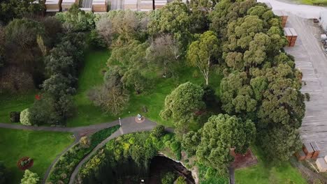 Aerial-view-of-a-magical-sinkhole-in-Australia,-surrounded-by-an-industrial-shipping-facility