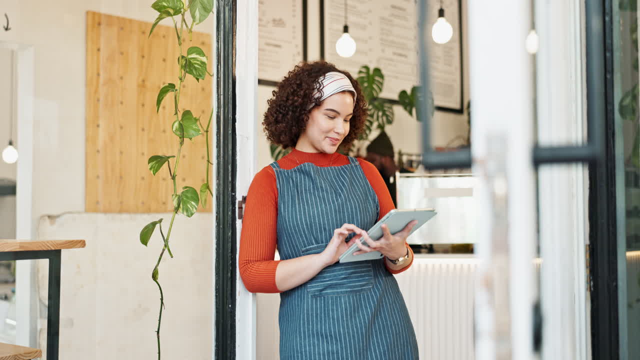 Woman managing her cafe business with a tablet