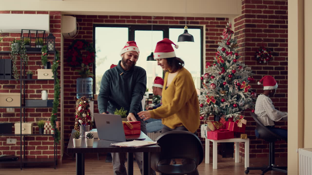 Festive people exchanging presents in decorated office
