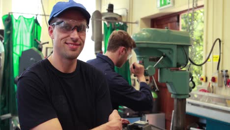 young mechanic smiling at camera