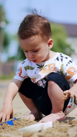 baby playing in the sand