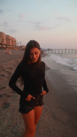 woman walking on a beach at sunset