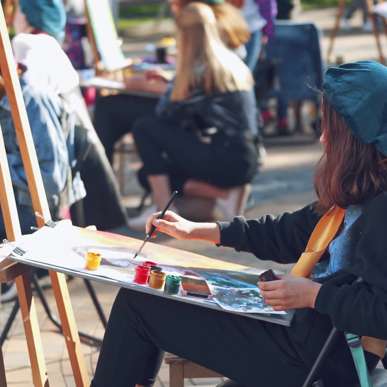 Young woman painting picture