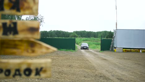 car parked at an entrance in a rural area.