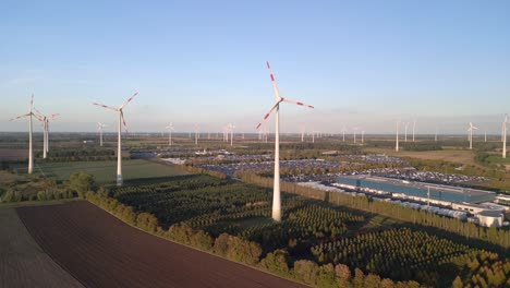 majestic aerial view flight panorama overview drone
of a wind farm wheel field next to industrial park at brandenburg germany at summer day 2022