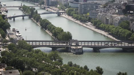 SLOW-MOTION:-Paris-Seine-river-with-touristic-boats-and-bridges,-France