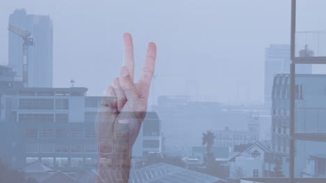 showing three fingers, hand in front of urban cityscape with misty buildings