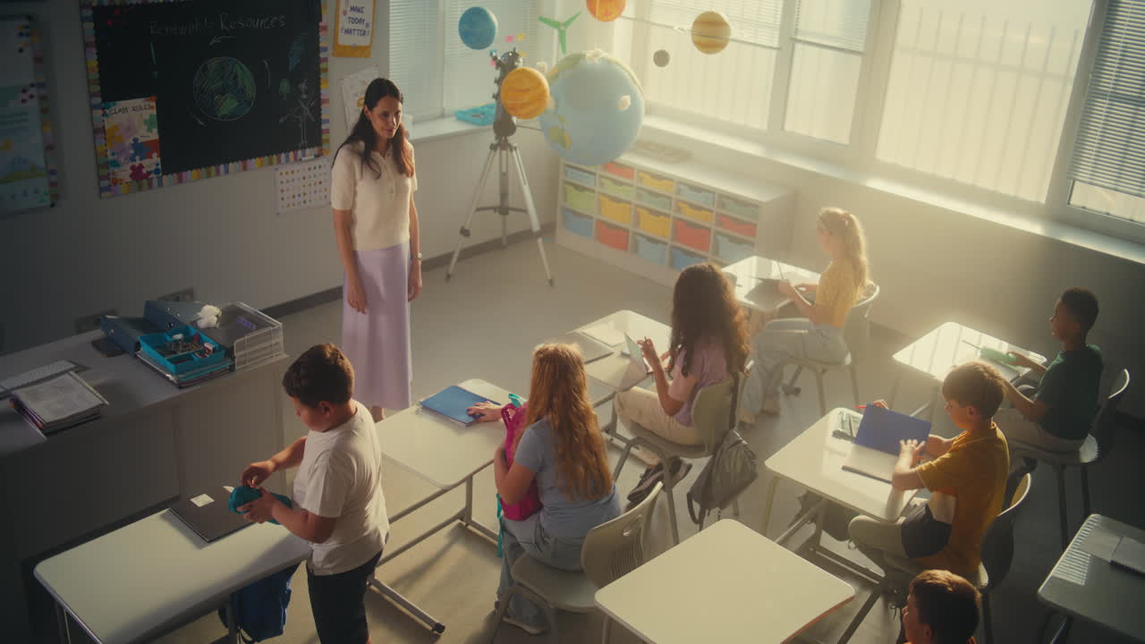 Female Teacher Greeting Group of Diverse Kids at the Beginning of School Day