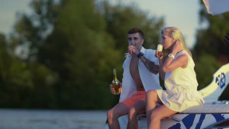 happy lovers with glasses of champagne on yacht. romantic date outdoors