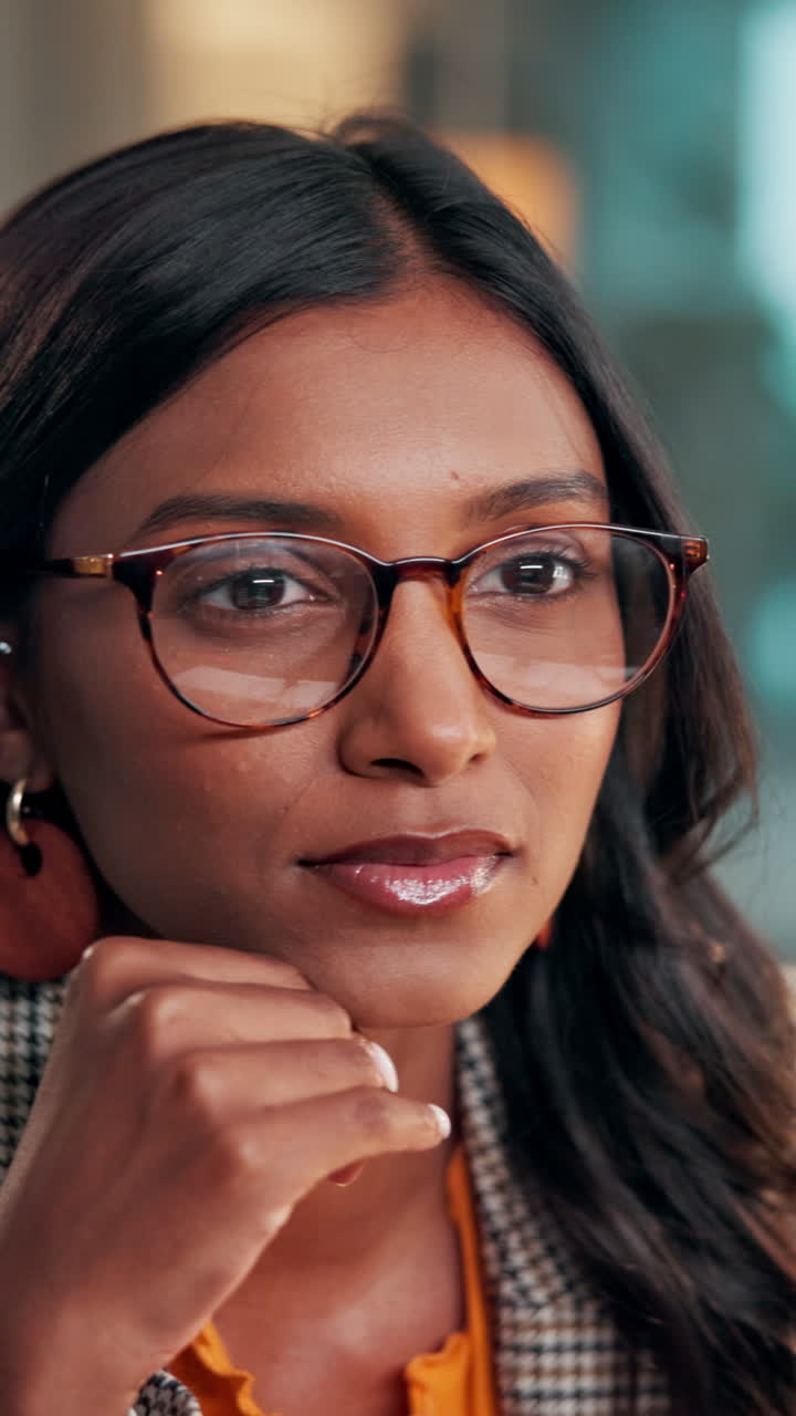 Close-up of a Thoughtful Professional Woman in Glasses