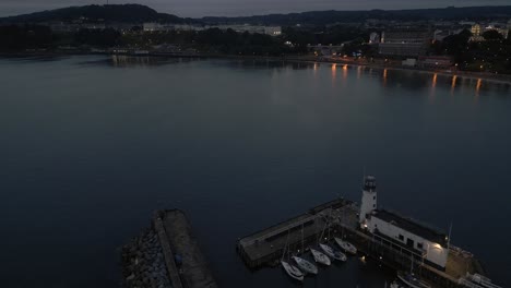 Establishing-Night-Drone-Shot-of-Scarborough-Lighthouse-and-Town