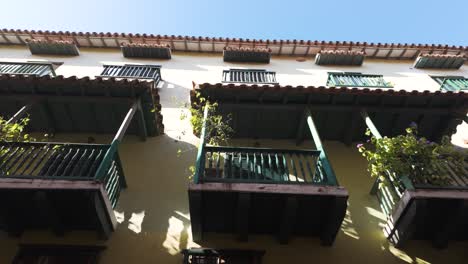 Looking-Up-At-Traditional-Colonial-Style-Wooden-Balconies-in-Cartagena,-Colombia