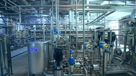 automated system of equipping at diary plant. difficult and complicated pipelines for processing milk. dolly shot.