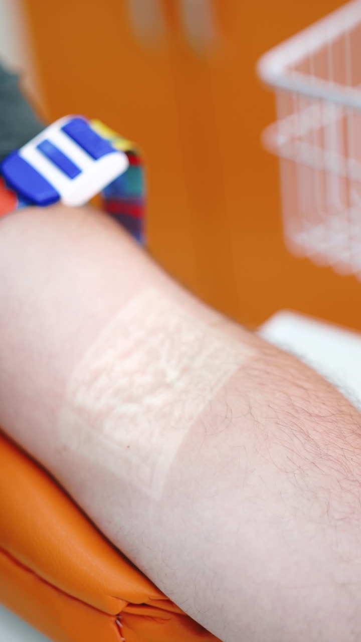 Close up of blood sampling. Doctor take blood sample from vein for testing. Vertical video