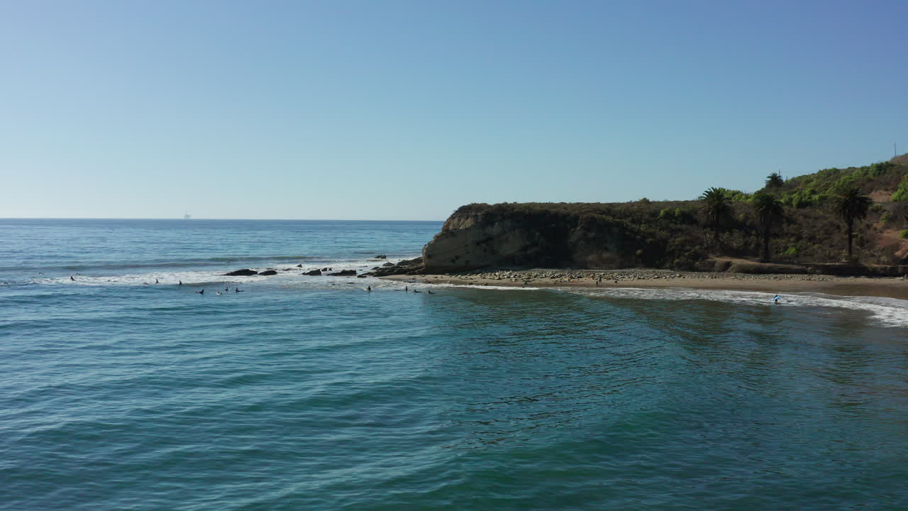 tranquila entrada del océano a lo largo de la costa de california con gente en una playa distante