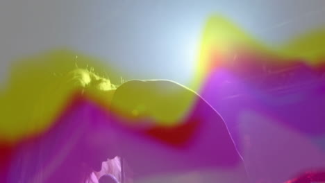 woman singing and leaning into microphone on stage, with animated music waves and lens flares