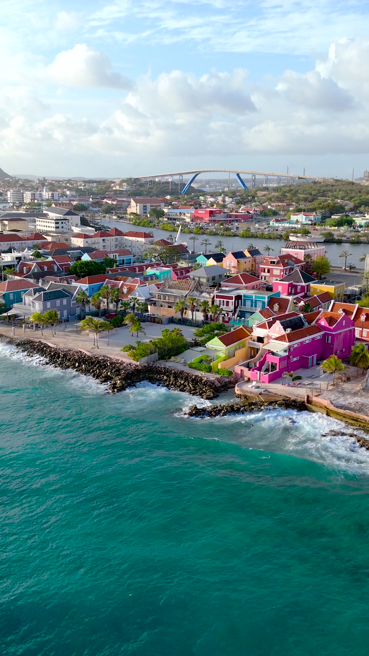 Vertical HD drone view of Pietermaai coastline at sunset with colorful architecture and tropical waterfront scenery.