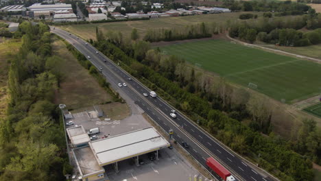 petrol station under construction and highway full of cars, aerial drone view