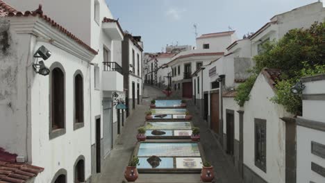 aerial pullback, paseo de canarias, tiled murals street in firgas, gran canaria island