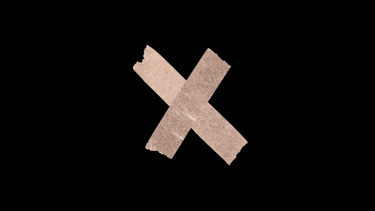 Crossed Adhesive Tape Forming an X Mark on Black Background