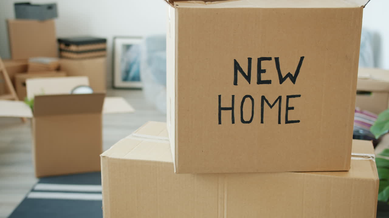 Moving Boxes with "New Home" Sign
