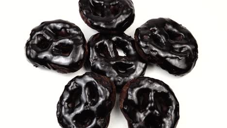 chocolate cookies with chocolate icing are on the white background