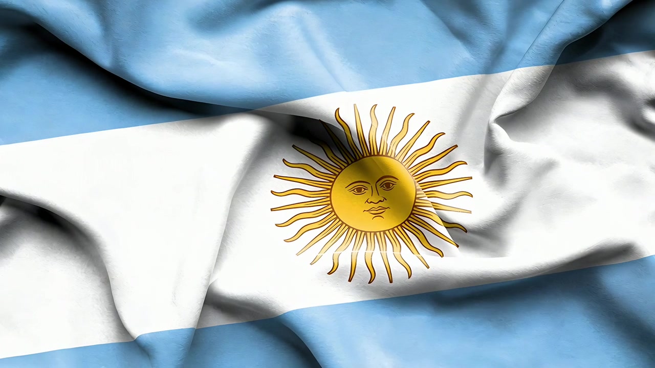 Argentinsk flagstof vifter let i en blid brise og viser Majsol-emblemet i et nærbillede i fuld ramme.
