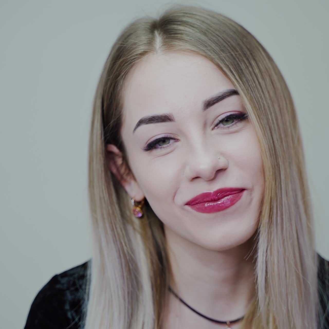 Portrait of beautiful young woman. Smiling girl with perfect make-up looking at camera. Happy face of attractive female. Close-up.
