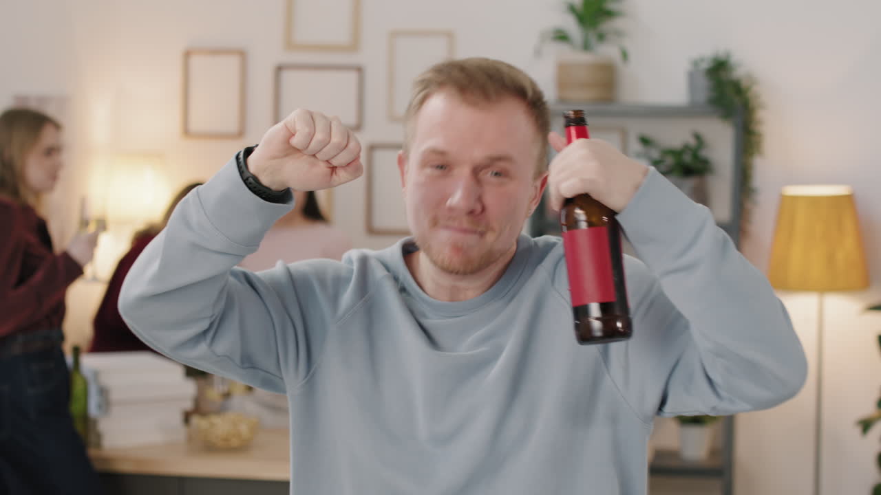 Tipsy Man with Beer Bottle Dancing at House Party