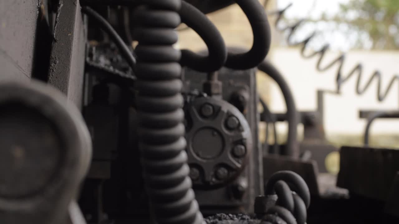 Industrial plant machinery engine motor close up crane tilting shot