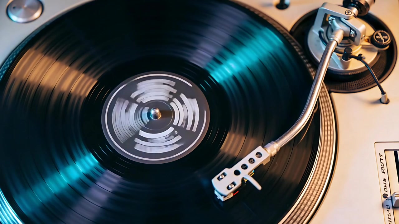 Spinning vinyl record and tonearm tracking inward on turntable, stylus engaging to play music