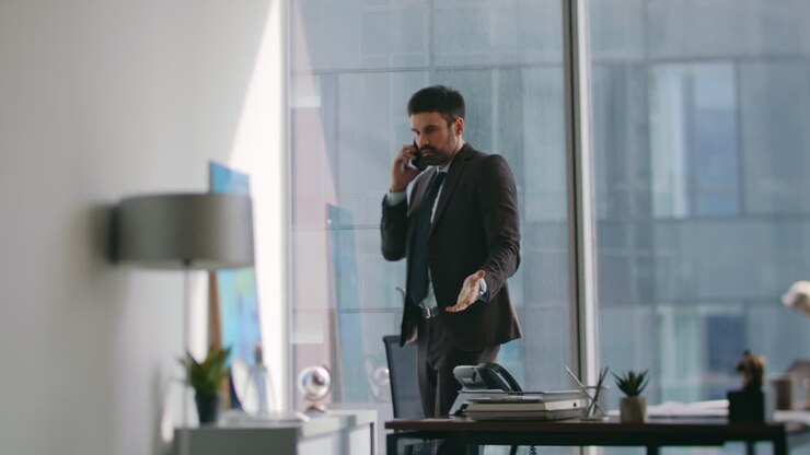 Frustrated ceo talking cellphone at office dissatisfied report. Annoyed manager