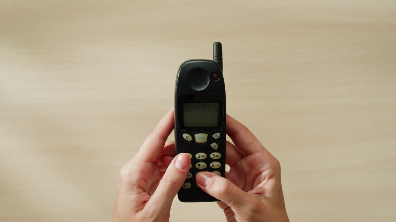 Old Cell Phone in Hands