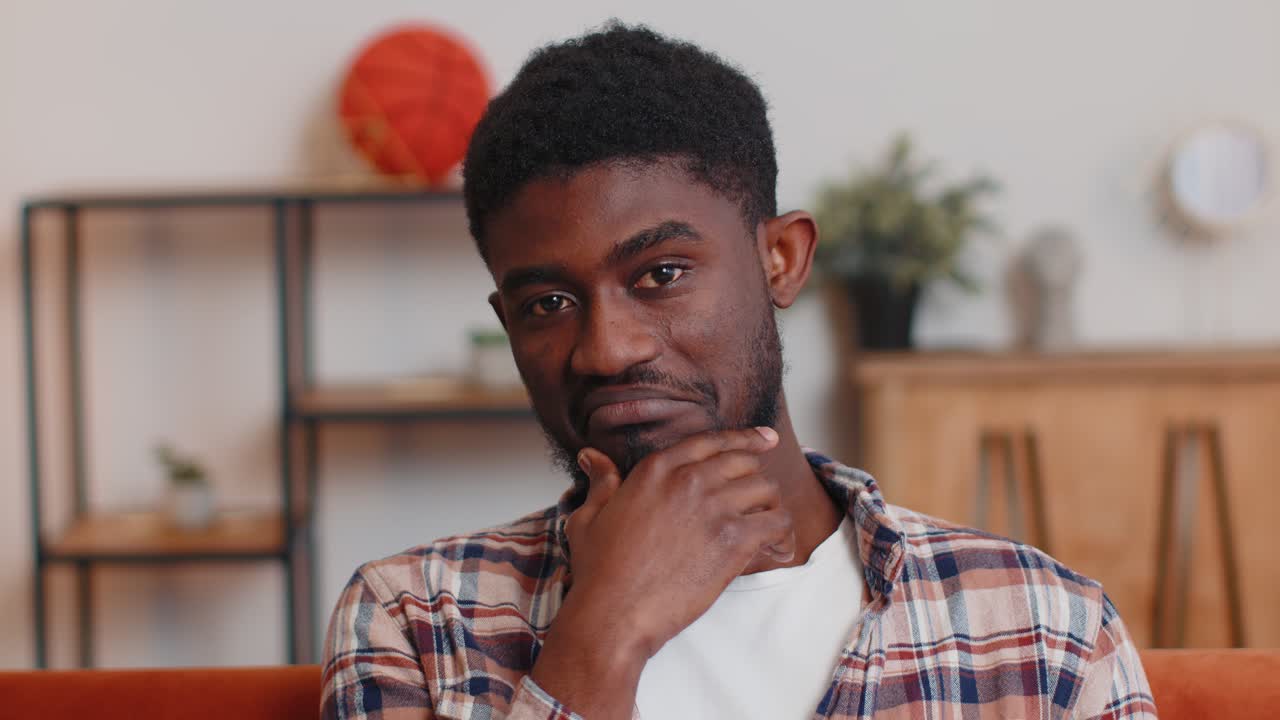 Lovely playful happy man african american smiling blinking eye looking at camera with toothy smile