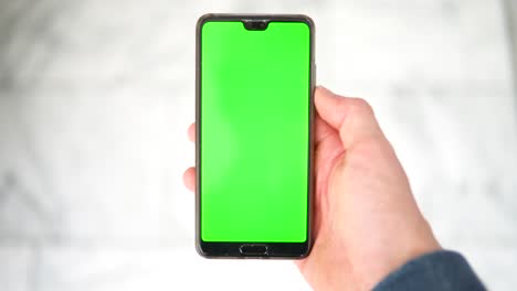 top-down pov shot of smartphone with editable greenscreen