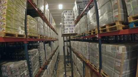 forklift stacking goods on the rack in the warehouse stockroom